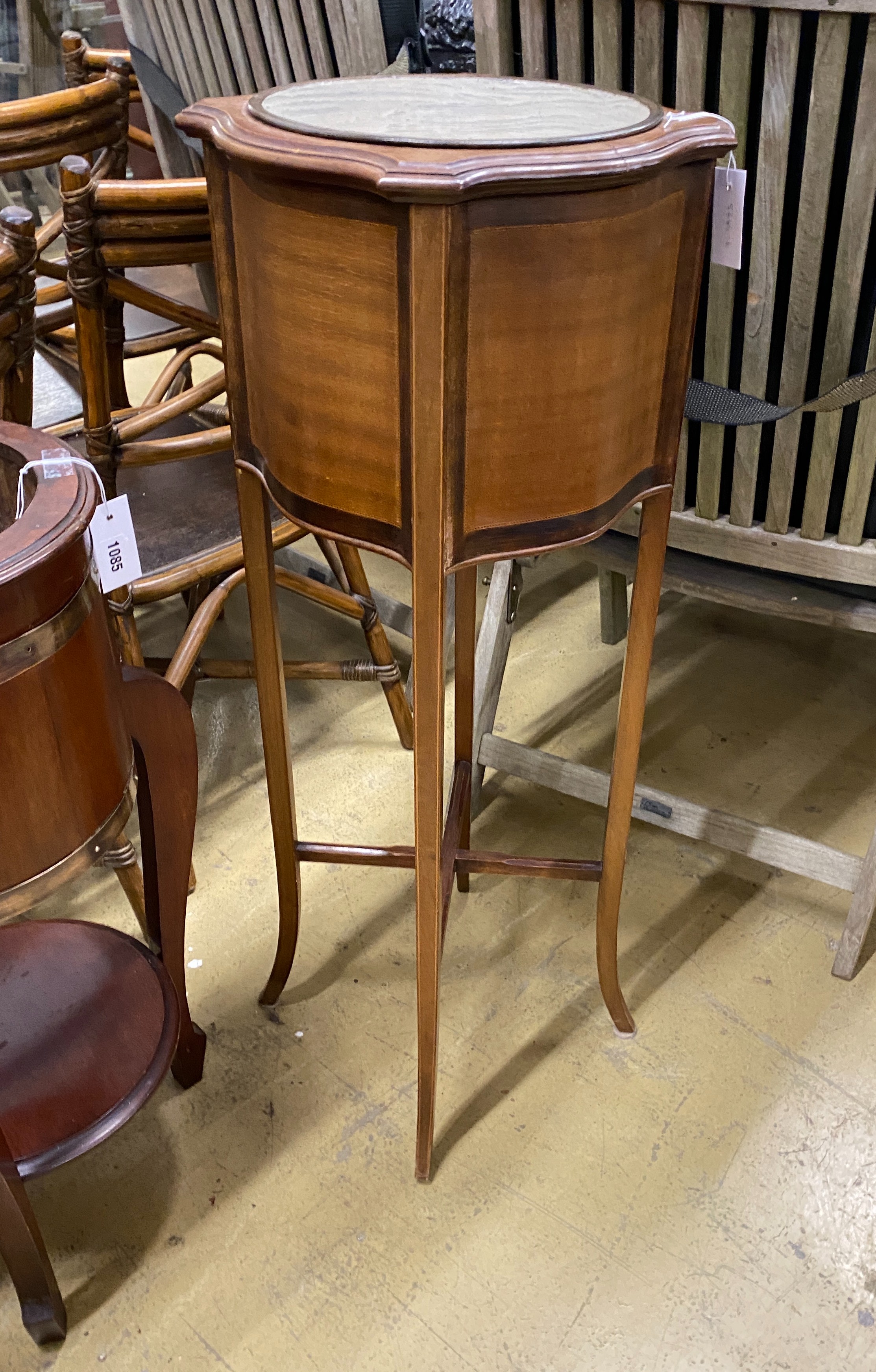 An Edwardian inlaid mahogany jardiniere of circular serpentine form, width 37cm, height 99cm
